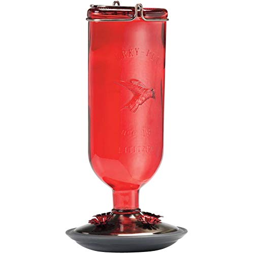 Red hummingbird feeder with a gray base 