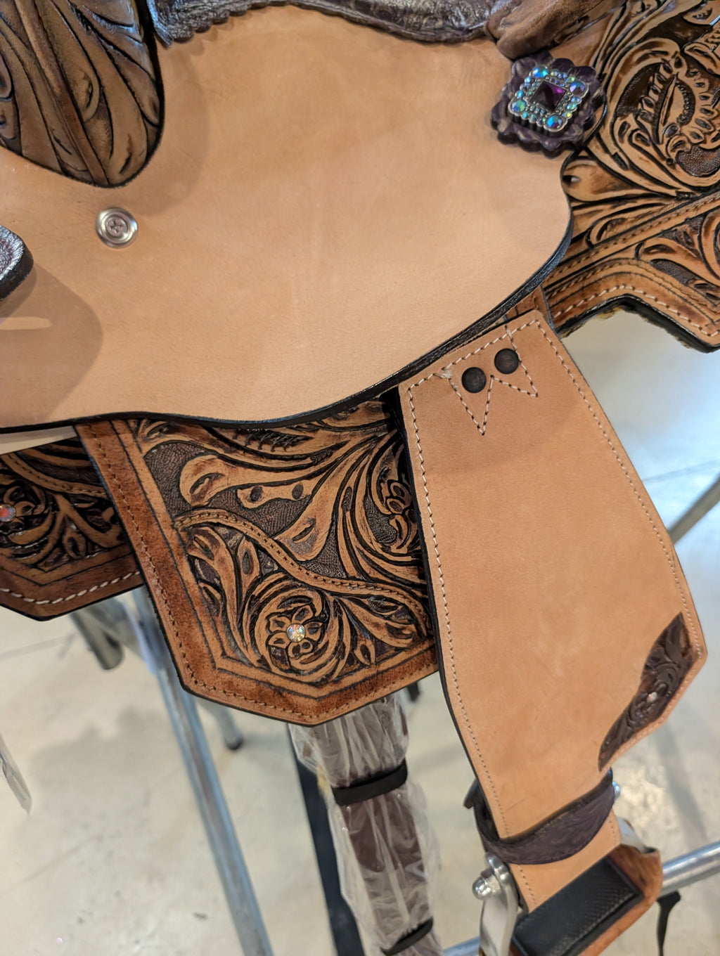 Close up of the details of the side of the Silver Royal saddle showing the rough out fender and tooling.