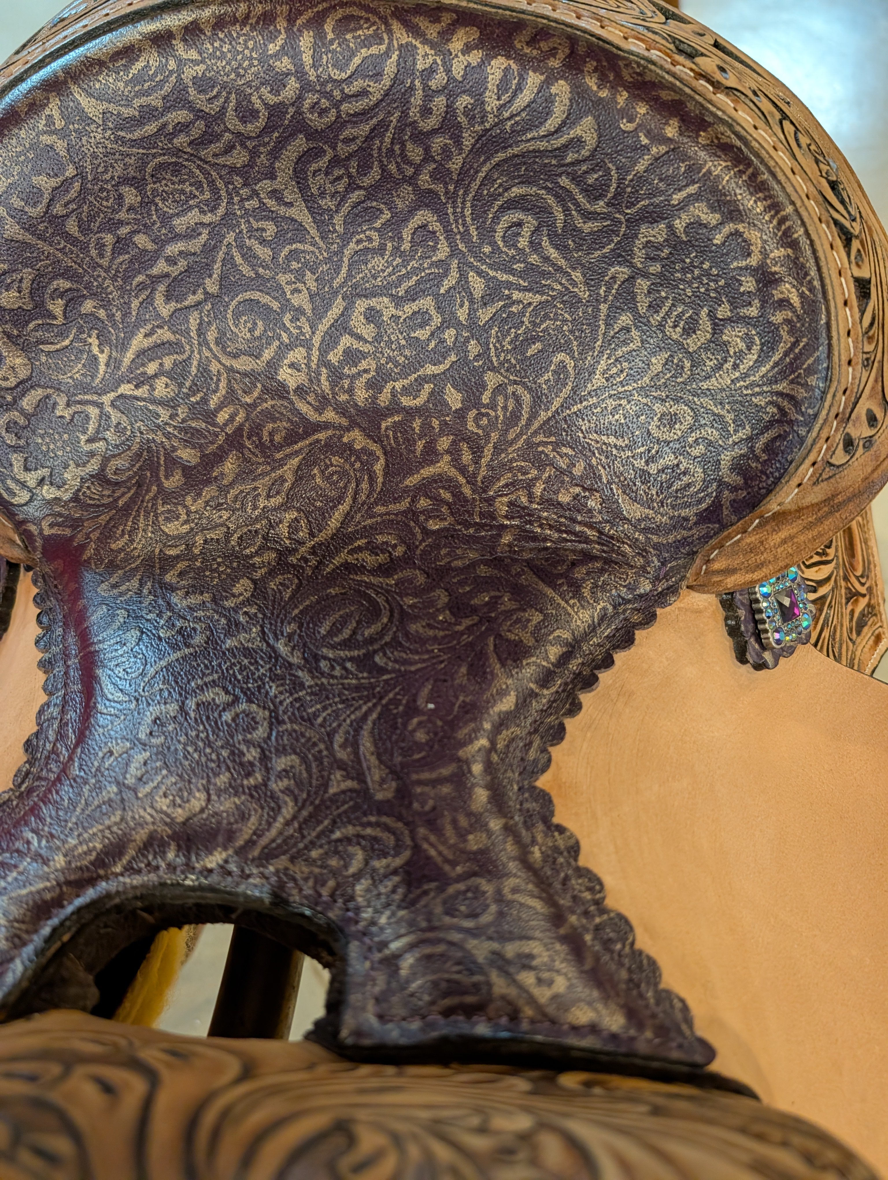 Close up of the seat of the saddle with purple and gold floral