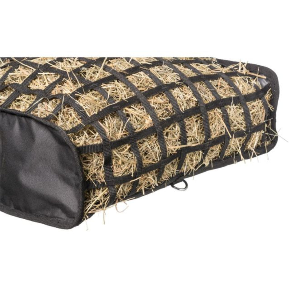 A black hay net cover with a grid pattern holding natural straw hay, shown on a solid white background.