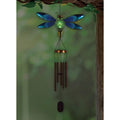 Decorative wind chime shaped like a dragonfly with a glowing effect on a green background
