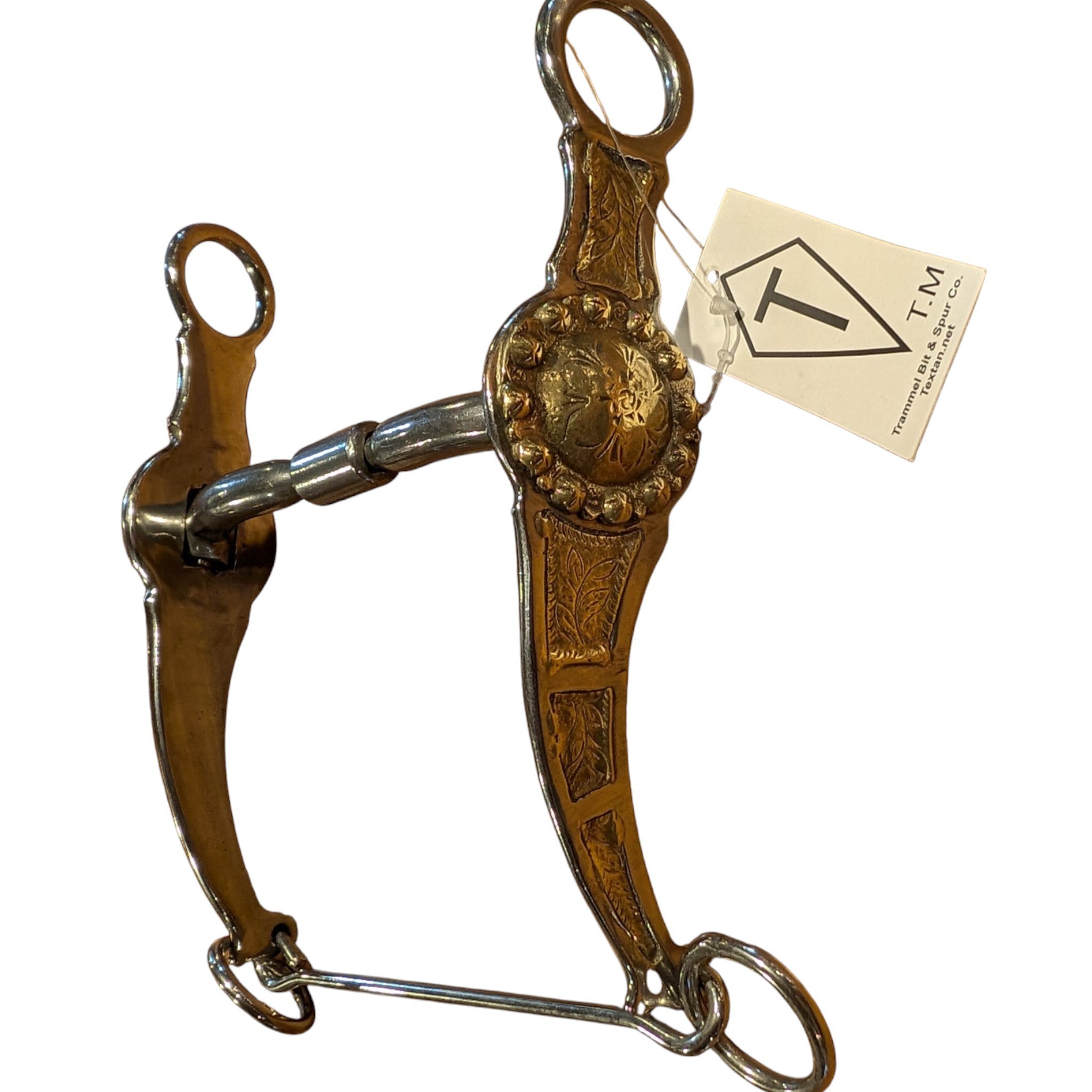 Engraved Western show bit by Trammel Bit & Spur Co. featuring detailed floral shanks, decorative circular conchos, and a center roller mouthpiece, with original brand tag attached
