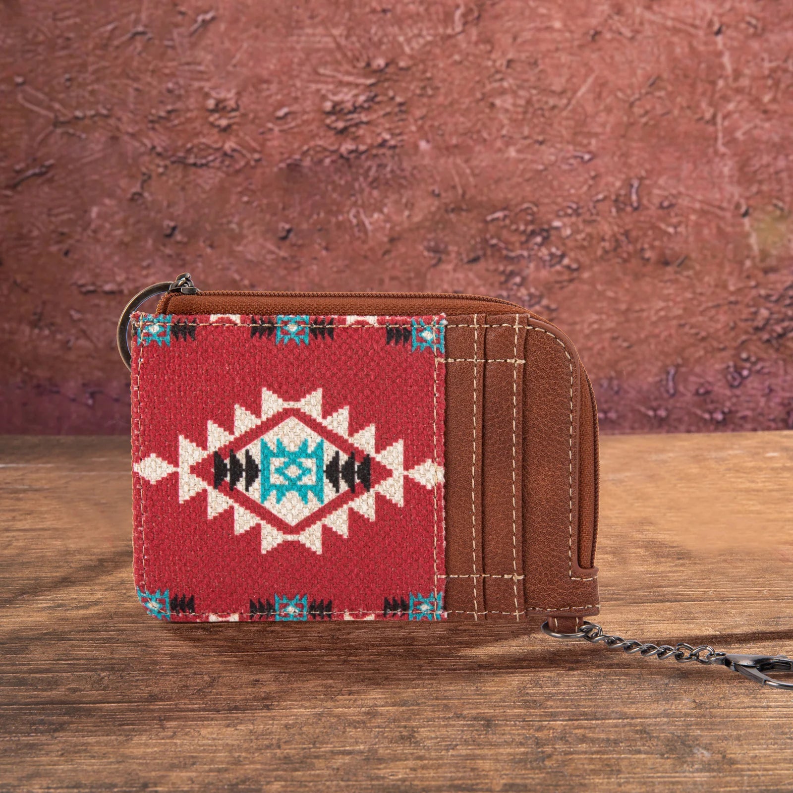 Red Wrangler by Montana West Southwestern print mini zip card holder on a rustic wooden background.