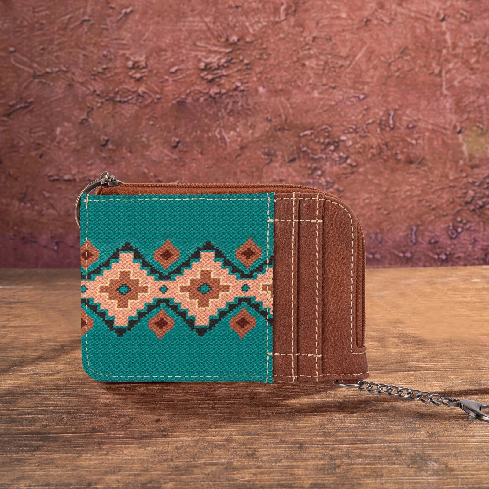 Turquoise Wrangler by Montana West Southwestern print mini zip card holder on a rustic wooden background.